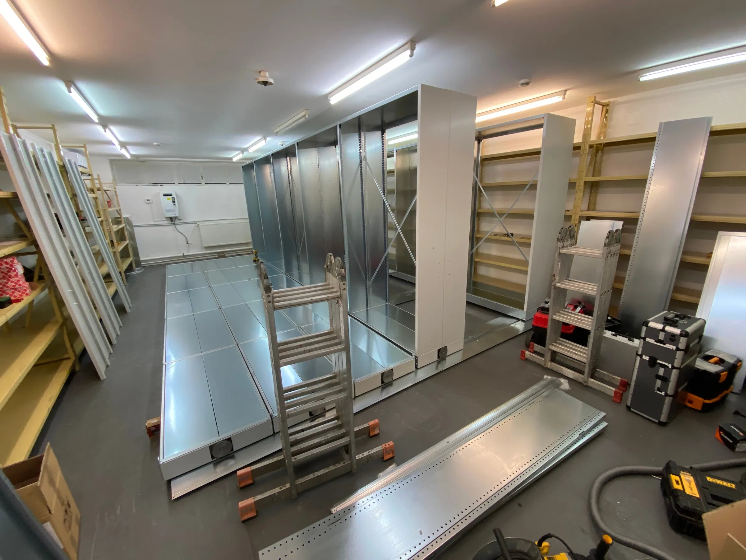 The mobile shelving rails on the archive floor, with the first units raised