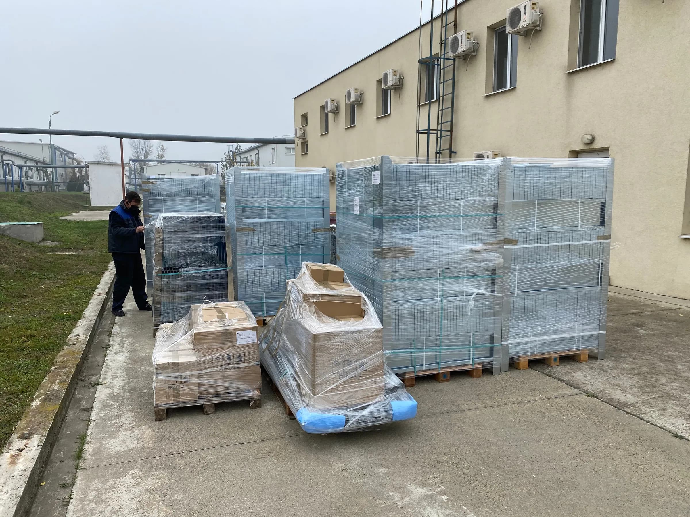 The shelving packed on pallets on delivery, in the building yard