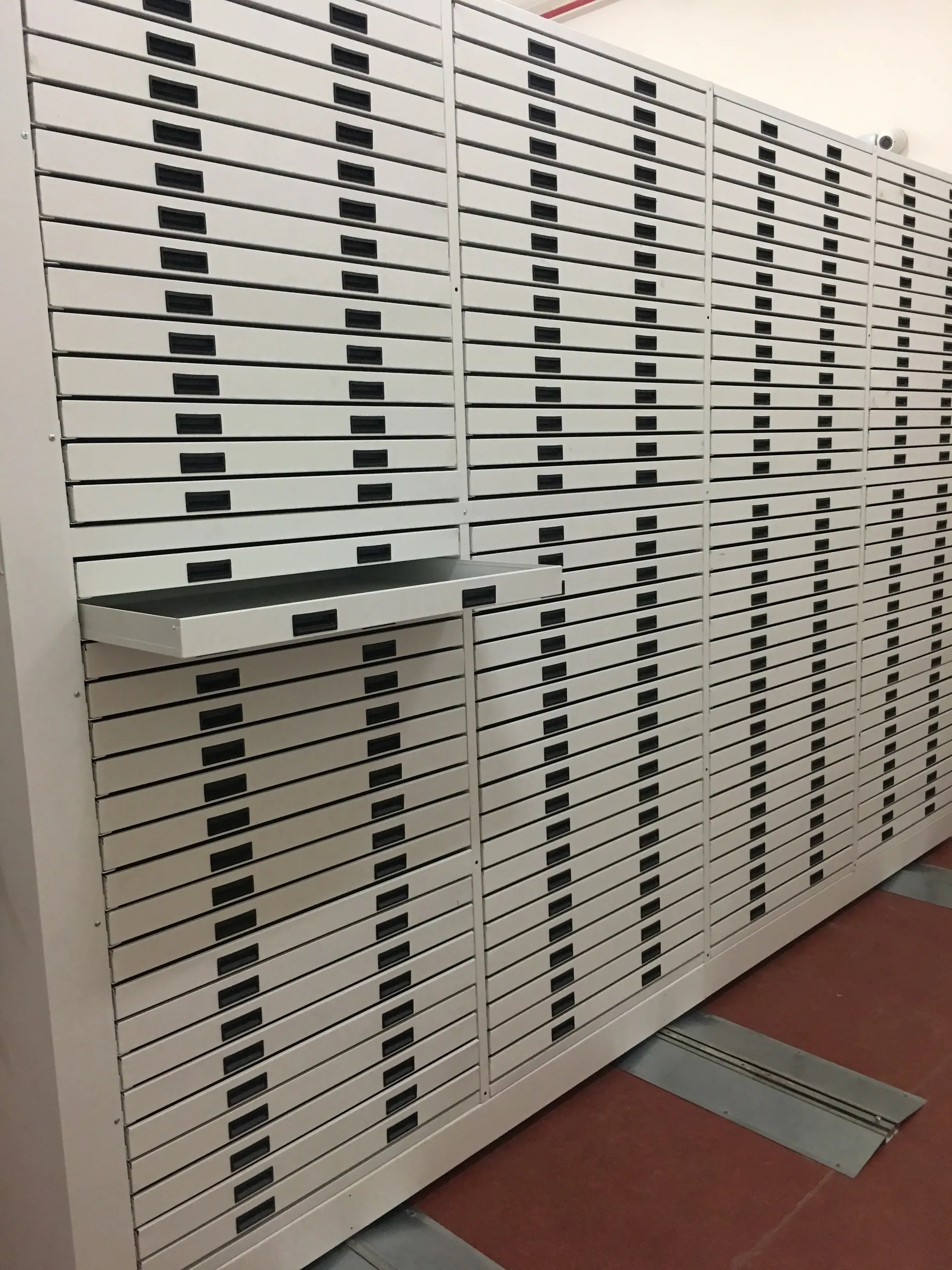 A unit with dozens of flat drawers, one pulled out